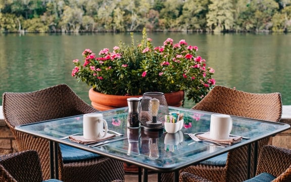 A set of one tables and chairs outdoor by the lake